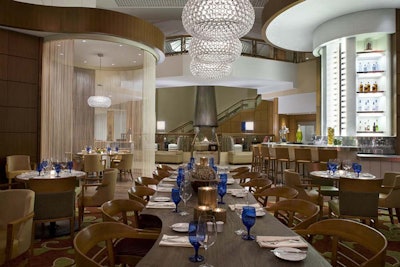 The dining room at Trios Bistro features a wall of windows overlooking Trinity Square.