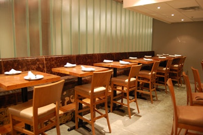 A frosted glass wall divides the space—a former carport—from the lobby of the neighbouring office building.