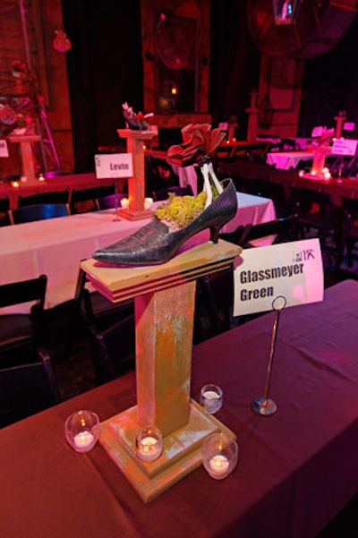 Shoes decorated pedestals at each dinner table, where signage called out various sponsors.