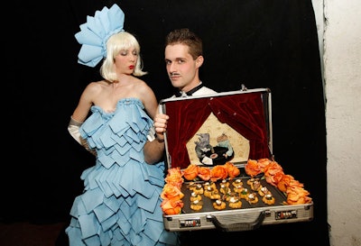 Guests pulled appetizers from a suitcase and napkins from a performer's dress.