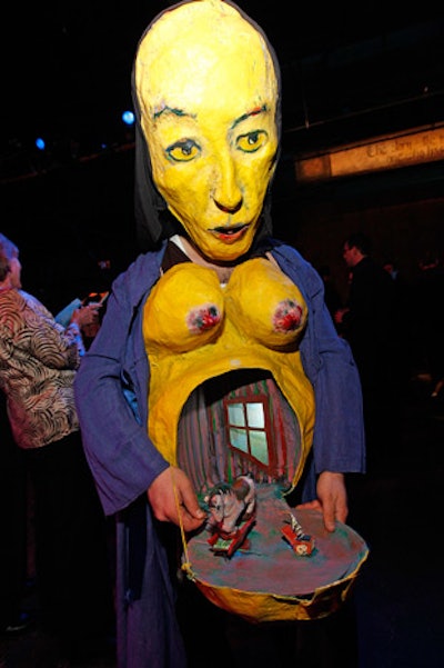Performers dressed as pregnant women opened papier-mâché bellies to reveal tiny puppet shows.