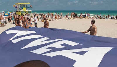 Cosmo 'sunscreen ambassadors' held a banner for event sponsor Nivea in front of the women on the beach for the aerial photograph.