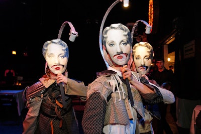 A trio of singers, armed with masks and individual spotlights, sang short ditties for individual guests.