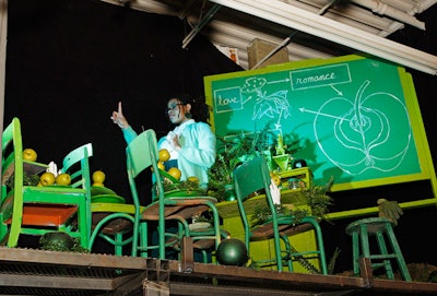 In a loft above the coat check area, an actor posed as a teacher and lectured an audience of chairs filled with green apples.
