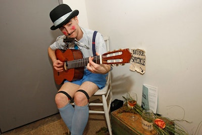 A rosy-cheeked guitarist serenaded guests while they waited in line for the restroom.