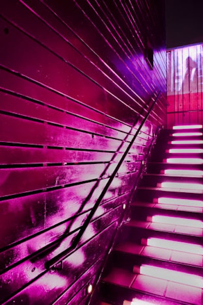 Organizers lit the stairs leading to the upper patio in pink and screened an avant-garde video on the wall halfway up the staircase.