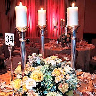 Dinner tables featured large centerpieces of lush roses and hydrangea by Floralia set atop shimmering gold tablecloths.