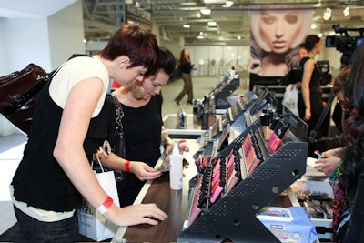 Makeup artists perused new collections by beauty brands.