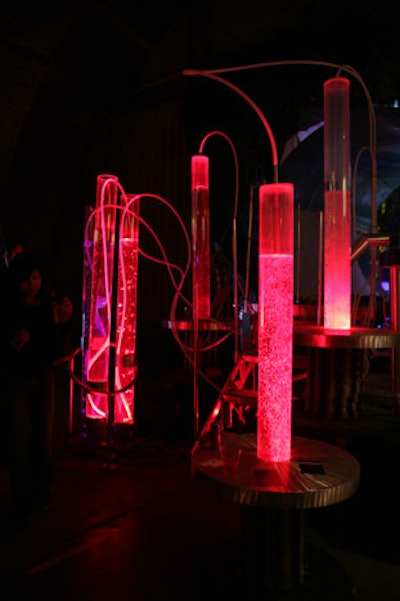 Lit up vials of liquid churn and bubble above some of the tables on the perimeter of the dance floor.