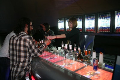 Custom glass refrigerators behind one of the bars contain three varieties of Red Bull.