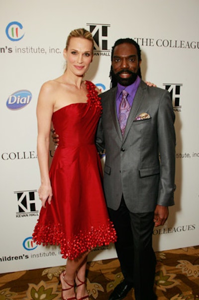 Molly Sims posed with designer Kevan Hall at the arrivals area.