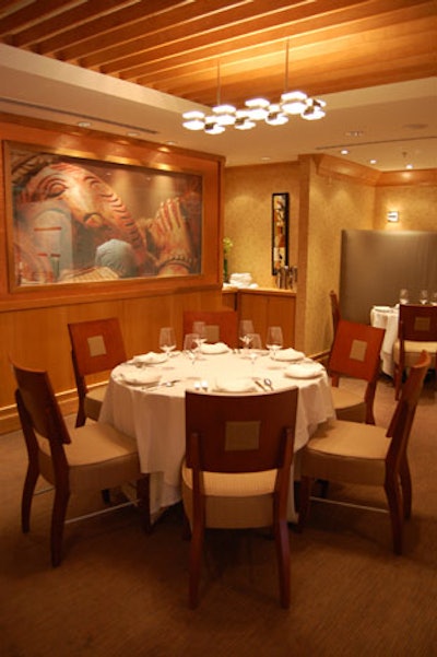 A sheer printed screen, which looks like a painting, offers views into the kitchen.