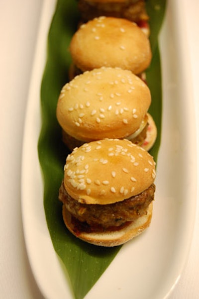 Noble Culinary Creations Catering prepared mini lemon-veal burgers in hand-formed sesame rolls with gruyere cheese, cranberry ketchup, and mushroom mayonnaise.
