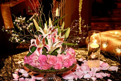 Centerpieces of lilies and roses hand-dipped in gold glitter topped the low-lying tables in the main seating area.