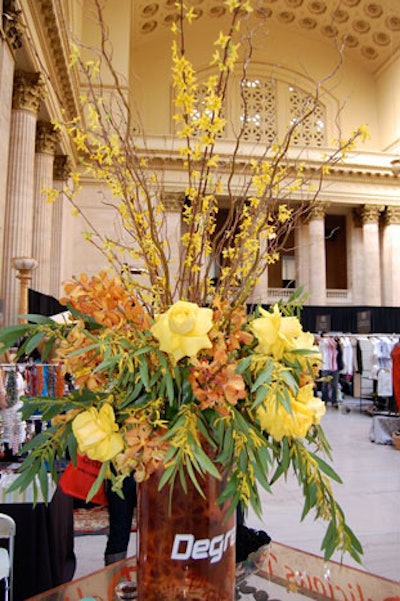 Branded vases held oversize floral arrangements in the Degree lounge.