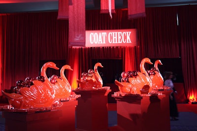 Five red ceramic swans perched on red pedestals and filled with red glass ornaments served as the focal point of the auction area.