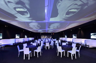 A scrim hanging overhead showed a kinetic display of still images under the tent at the Annenberg Space for Photography's opening night party.