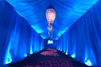 Blue lighting bathed the arrivals tent, where chandeliers hung overhead for a luxe look.