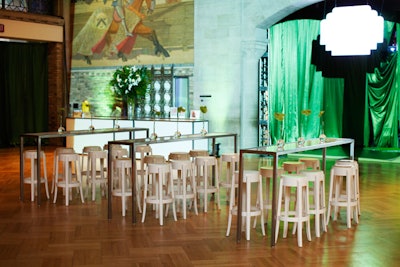White stools provided seating at tall, narrow tables throughout the space.