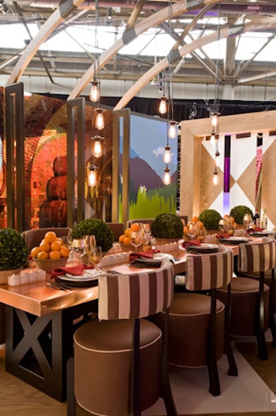 Marc Blackwell's installation for sponsor Castello Di Gabbiano evoked the winery's cellars with barrel-shaped chairs, large photo-screens of the property, and a copper tabletop.