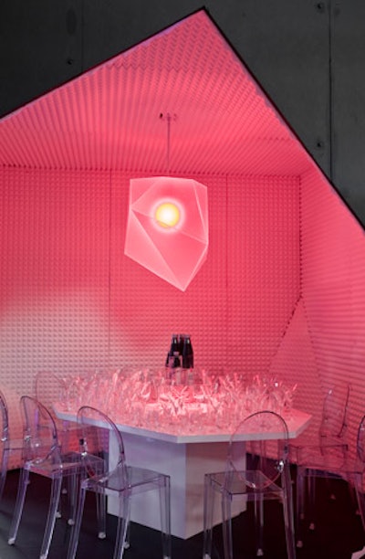 Fashion designer Jason Wu's table for Stolichnaya Elit included an ice-cube-shaped pendant light and a table covered in glassware.