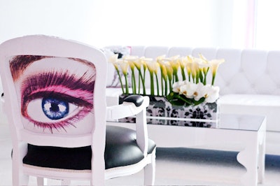An eye image backed a chair, and cala lilies sat in neat rows as centerpieces.