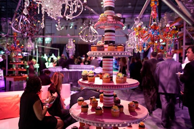 Capital Decor & Events made a cupcake tower from a tent frame and hung multicolored chandeliers overhead.