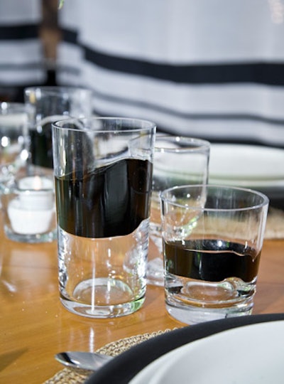 Ralph Lauren Home mixed tumblers with a black band and a single piece of stemware.