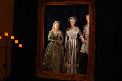 In place of costumed mannequins, three models posed in a tableau vivant, recreating poses from the promotional imagery that decorated the party.