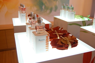 Small bundles of red tea leaves lay beside bottles of the new Roots Source Red Tea eau du parfum on a display case in the centre of the store.