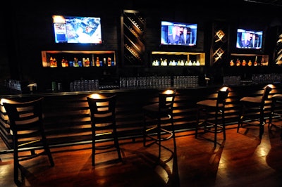 Behind the upstairs bar, seven-foot-high vertical cabinets hold bottles of wine.