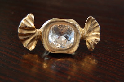 A bow-shaped ring was sent to guests with the invitation to the media preview.