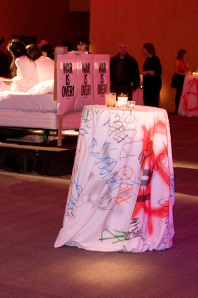 White linens marked with graffiti tags topped cocktail tables in Baillie Court.