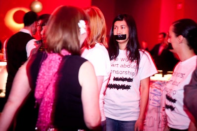 Volunteers with black tape pasted across their mouths protested censorship in an installation at the event.