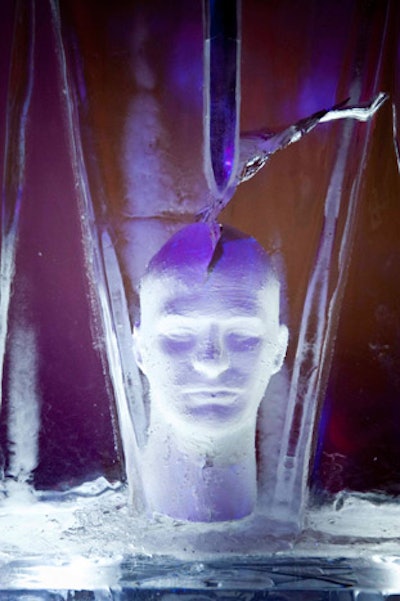Artist Jay Issac encased a sword—balancing on a sculpture of a human head—in ice.