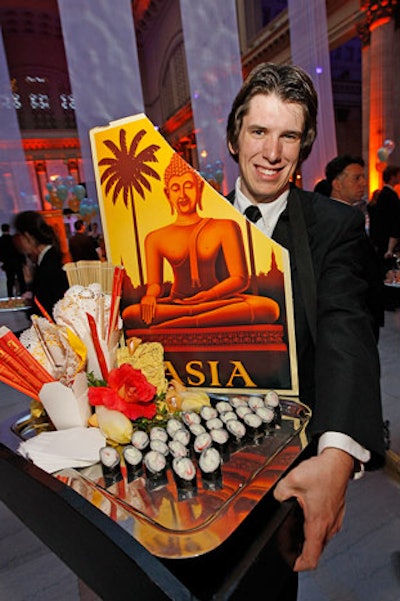 Jewell Events Catering decorated appetizer trays with postcards and paraphernalia from different countries.