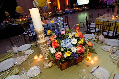 On dinner tables, colorful flowers spilled out of prop suitcases.