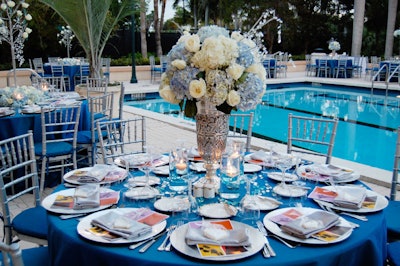 National Flowers created three centerpiece designs, each with a combination of white and blue hydrangeas and white Virginia roses, accented with strings of Swarovski crystals.