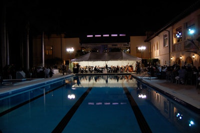 The orchestra performed an hourlong concert under a tent at the end of the pool.