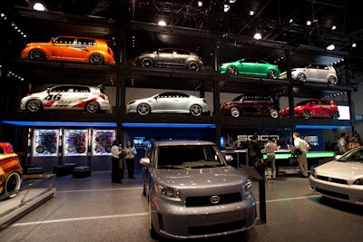 Scion stacked eight of its models in a towering rack display that doubled as a video space when projection screens dropped in front of the cars.