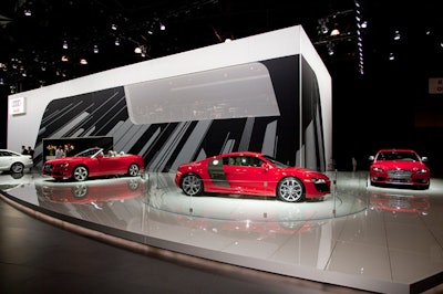 Above Audi's booth, the company built a small cafe that overlooks the models through a sheer curtain.