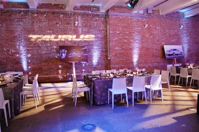 The simple decor at Ford's design dinner included four tables for 10 and uplit brick walls with Taurus gobos.