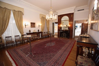 The embassy staff removed an 18-seat dining table in the formal dining room, making way for three glass and chrome high-tops.