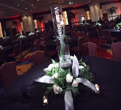Each dining table held a cylindrical glass vase etched with the table sponsor's name.