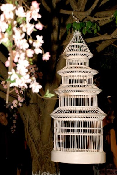 David Glass hung white bird cages and strings of small pink flowers from the trees surrounding Estrada's display.