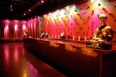 Large gold Buddha statues sit atop the mezzanine-level bars on both sides of the club.