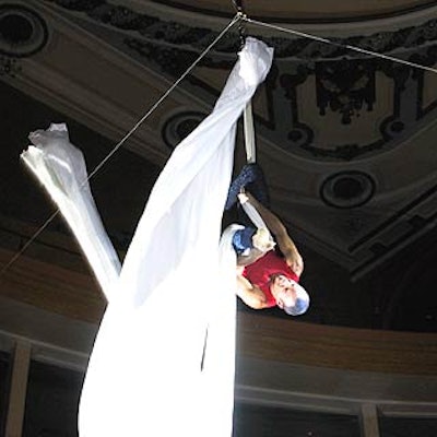 Aerialist Jonathan Nosan performed a routine on a long piece of white fabric hanging from the ceiling.