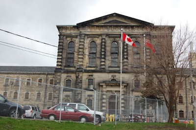 A carving of Father Time hangs over the main door of the jail, which is currently fenced in. The fencing will be removed before the facility becomes available as an event space this summer.