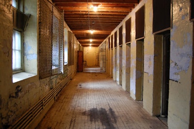 The indoor gallows—the site of 26 executions—are located through a doorway halfway along a cellblock on the second floor.