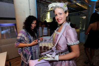 Two girls dressed in lilac and silver dresses offered sweets from Moroco Chocolat, a chocolate boutique and lounge in Yorkville.